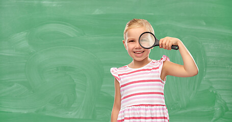 Image showing girl looking through magnifying glass at school