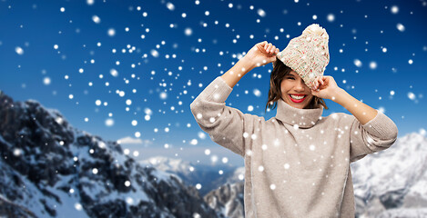 Image showing young woman in knitted winter hat in mountains