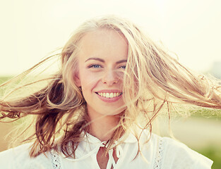 Image showing close up of happy young woman in white outdoors