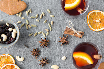 Image showing hot mulled wine, orange slices, raisins and spices