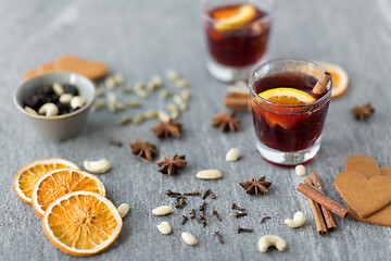 Image showing hot mulled wine, orange slices, raisins and spices