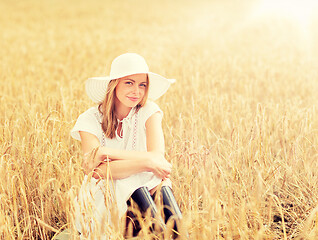 Image showing happy young woman in sun hat on cereal field