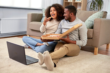 Image showing happy african american couple eating pizza at home