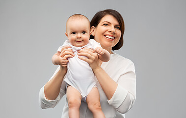 Image showing happy middle-aged mother with little baby daughter