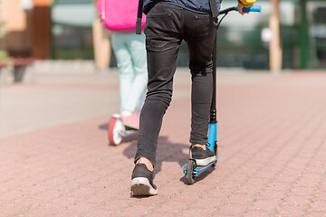 Image showing school children with backpacks and scooters