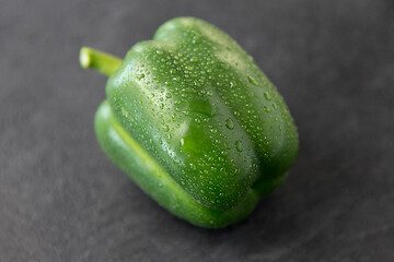 Image showing close up of green pepper on slate stone background