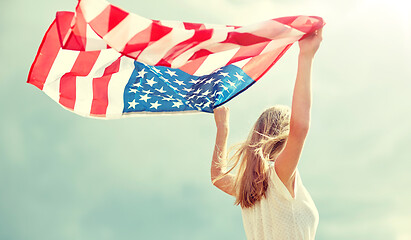 Image showing happy young woman with american flag outdoors