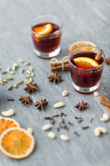 Image showing hot mulled wine, orange slices, raisins and spices