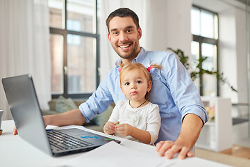 Image showing working father with baby daughter at home office