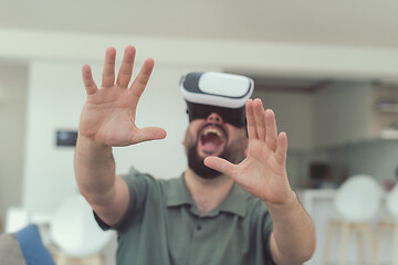 Image showing man with beard trying vr glasses