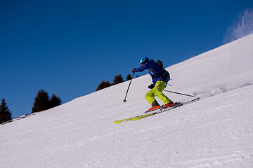 Image showing Skier having fun while running downhill