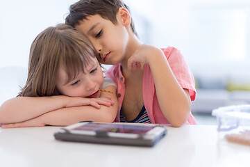 Image showing cute little brother and sister having fun at home