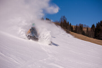 Image showing snowboarder crashes while carving down