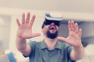 Image showing man with beard trying vr glasses