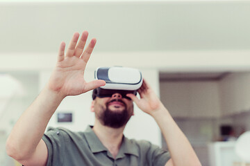 Image showing man with beard trying vr glasses