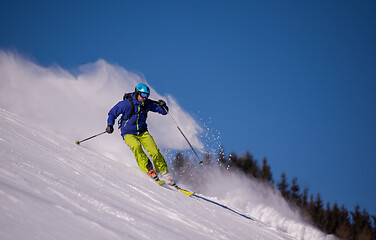 Image showing Skier having fun while running downhill