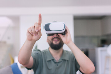 Image showing man with beard trying vr glasses