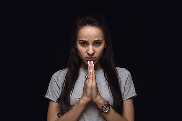 Image showing Close up portrait of young woman isolated on black studio background