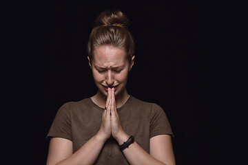 Image showing Close up portrait of young woman isolated on black studio background