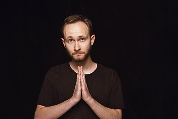 Image showing Close up portrait of young man isolated on black studio background