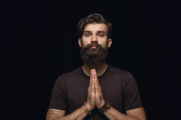 Image showing Close up portrait of young man isolated on black studio background