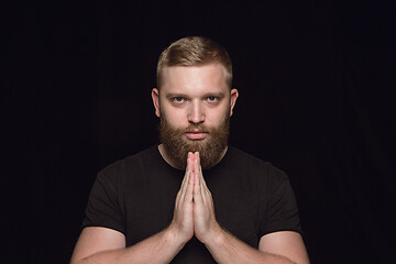 Image showing Close up portrait of young man isolated on black studio background