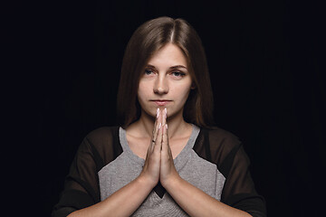 Image showing Close up portrait of young woman isolated on black studio background