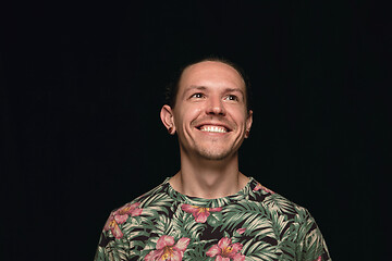 Image showing Close up portrait of young man isolated on black studio background