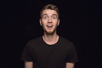 Image showing Close up portrait of young man isolated on black studio background