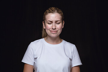 Image showing Close up portrait of young woman isolated on black studio background