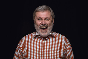 Image showing Close up portrait of senior man isolated on black studio background