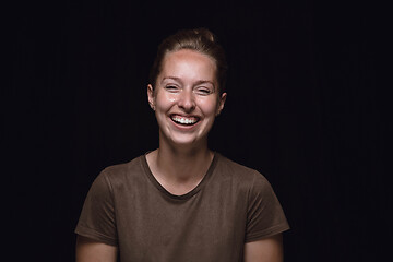 Image showing Close up portrait of young woman isolated on black studio background