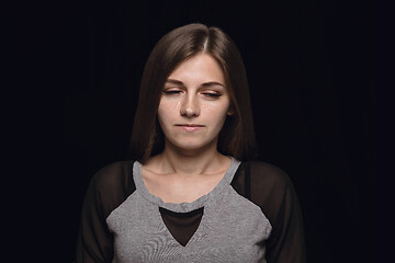 Image showing Close up portrait of young woman isolated on black studio background