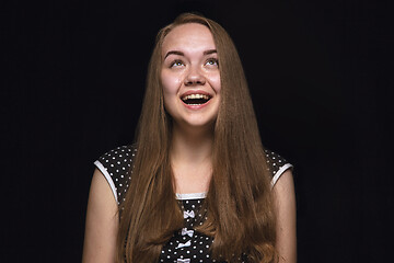 Image showing Close up portrait of young woman isolated on black studio background