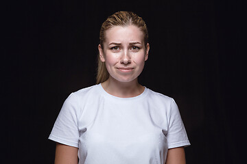 Image showing Close up portrait of young woman isolated on black studio background