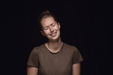 Image showing Close up portrait of young woman isolated on black studio background