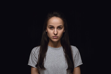 Image showing Close up portrait of young woman isolated on black studio background