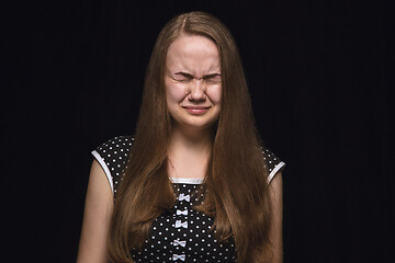 Image showing Close up portrait of young woman isolated on black studio background