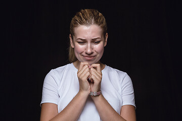 Image showing Close up portrait of young woman isolated on black studio background