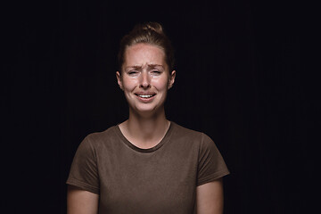 Image showing Close up portrait of young woman isolated on black studio background