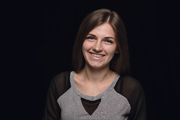 Image showing Close up portrait of young woman isolated on black studio background