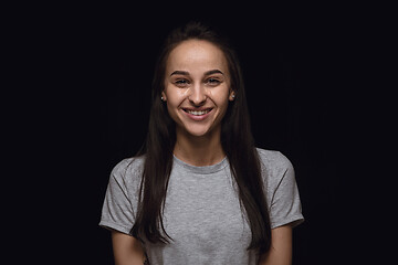 Image showing Close up portrait of young woman isolated on black studio background