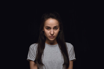 Image showing Close up portrait of young woman isolated on black studio background