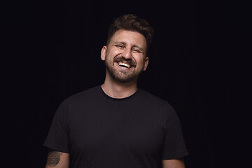 Image showing Close up portrait of young man isolated on black studio background