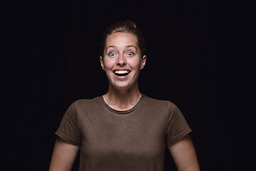 Image showing Close up portrait of young woman isolated on black studio background