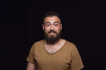 Image showing Close up portrait of young man isolated on black studio background