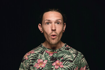 Image showing Close up portrait of young man isolated on black studio background