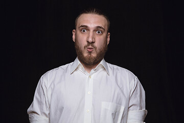 Image showing Close up portrait of young man isolated on black studio background