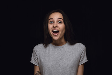 Image showing Close up portrait of young woman isolated on black studio background