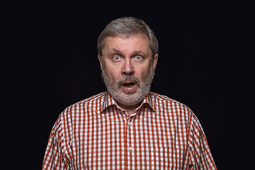 Image showing Close up portrait of senior man isolated on black studio background